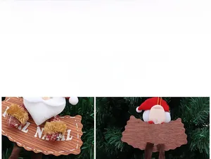 Detail of Santa plush ornament featuring a wooden sign with Feliz Navidad lettering