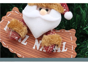 Close-up of Santa Claus wooden ornament with Feliz Natal text on festive pine needles