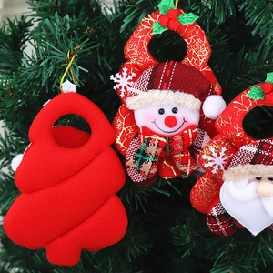Detailed view of Christmas felt ornaments featuring Santa and snowman on a tree