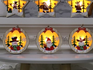 Detail of wooden Christmas ornaments with warm LED lighting featuring snowman and deer