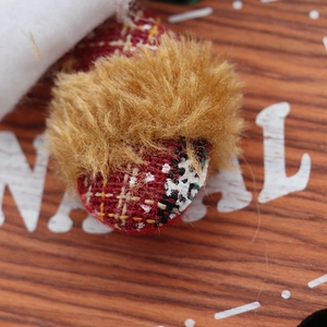 Christmas hanging ornament featuring red plaid fabric with white snowflake embroidery