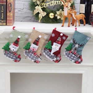 Detail of Christmas stocking set with 3D applique on fireplace with festive decor