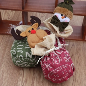 Détail de sacs cadeaux de Noël en toile avec décorations 3D de renne et bonhomme de neige