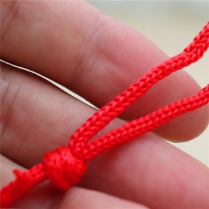 Detailed close-up of a red woven drawstring cord for Christmas gift bags and DIY crafts