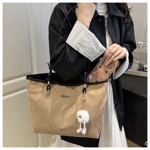 Détail du sac cabas plissé kaki montrant la capacité intérieure avec téléphone et bijou