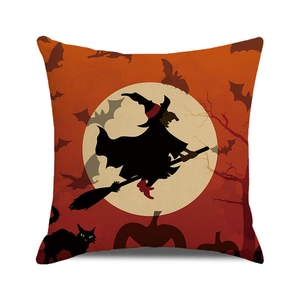 Detail of Halloween pillow case featuring a witch silhouette and pumpkins on orange fabric