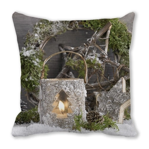 Detail of Christmas pillow cover featuring birch candle holder, pine cones, and snowy stars