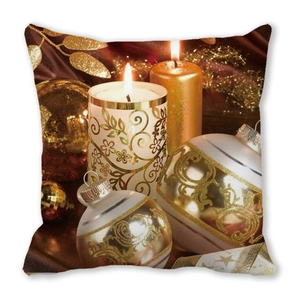 Detail of Christmas pillow cover with golden candles and festive leaf print