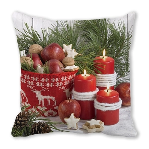 Macro shot of Christmas pillow featuring red candles, apples, and green pine branches