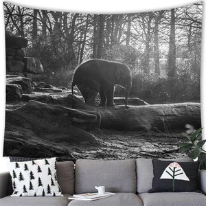 Detail of black and white African elephant tapestry hanging above a modern grey sofa