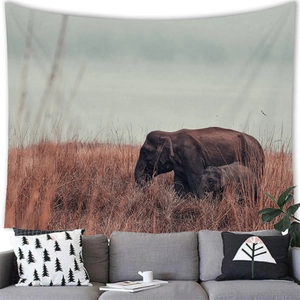 Detailed view of an African elephant tapestry hanging above a modern grey sofa décor