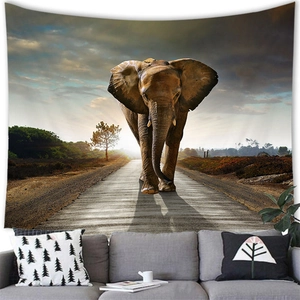African elephant sunset tapestry displayed above a grey sofa in a modern living room