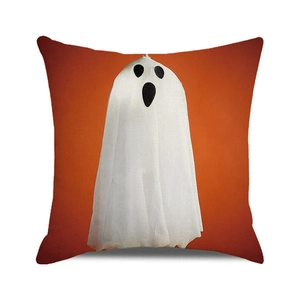 Close-up of Halloween orange pillow cover with white cartoon ghost and canvas texture