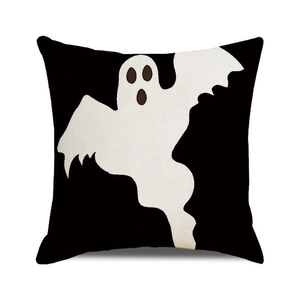 Detail of Halloween throw pillow cover with white ghost on black linen background
