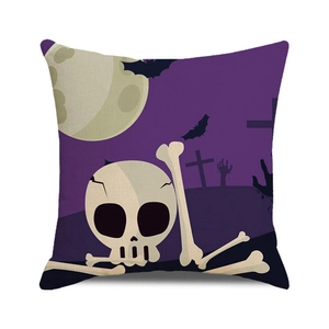 Macro detail of Halloween pillow cover featuring skulls, bats and moon on purple fabric