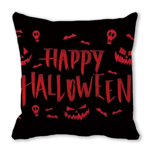Macro view of Happy Halloween cushion showing red skull and pumpkin print on black fabric