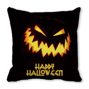 Close-up of black Halloween pillowcase featuring a glowing pumpkin face and festive text