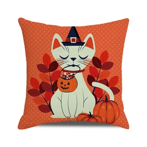 Close-up of Halloween cushion cover with cartoon white cat, pumpkin and orange polka dots