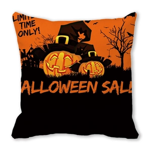 Close-up of Halloween pumpkin and castle prints on a soft peach skin throw pillow