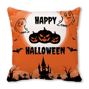 Detail of orange Happy Halloween pillow with pumpkin and castle silhouette prints