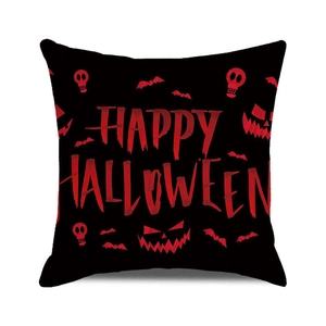 Detail of Happy Halloween pillow case with red font, bats, and skull silhouettes