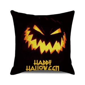 Detail of Halloween cushion cover with glowing pumpkin face and Happy Halloween text