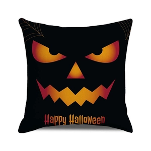 Detail of Halloween pillow case with aggressive pumpkin face and Happy Halloween text