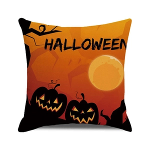 Detail of square Halloween cushion cover with orange pumpkin silhouette and linen texture