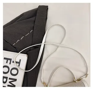 Detail view of white leather and mesh stitching on this trendy crossbody box bag
