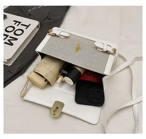 Detailed internal storage view showing a smartphone and umbrella in the contrast linen bag