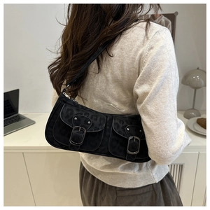 Détail du sac d'épaule noir avec texture léopard et poches avant à boucles doubles