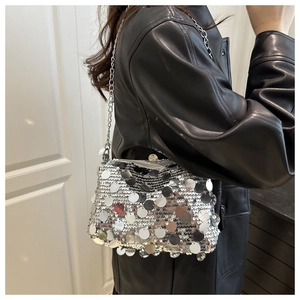 Detailed side view of silver sequin shoulder bag with metallic chain strap and zipper