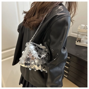 Detailed close-up of shiny silver sequin shoulder bag with elegant metal chain strap
