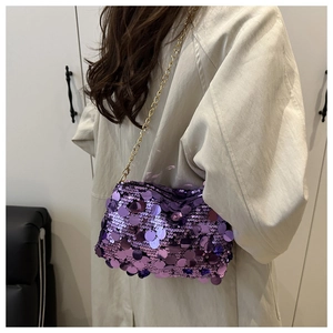 Detailed view of purple sequin crossbody bag with gold chain strap on a model