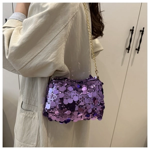 Detailed view of shimmering purple sequins and gold chain strap on stylish shoulder bag