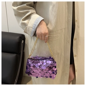 Detailed close-up of a purple sequined mini handbag with shiny gold chain strap