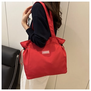 Detail of red nylon tote bag with drawstring closure and large capacity design
