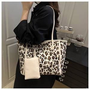 Detail of leopard print canvas tote bag with a small white hanging storage pouch