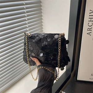 Fashionable black sequin dumplings bag with gold chain strap for shoulder or crossbody use