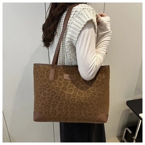 Detailed view of the leopard print tote bag featuring reinforced leather corners and brand logo