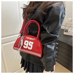 Detail of red patent leather bowling bag with white vintage athletic lettering