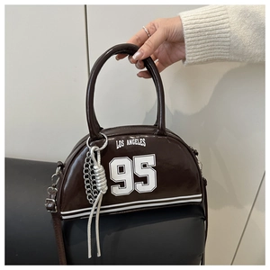 Detail of dark brown leather crescent bag with Los Angeles 95 print and silver chain link