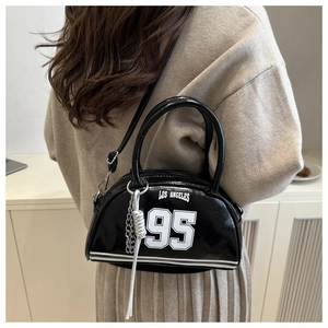 Detail of black crescent bag with white LOS ANGELES print and silver chain tassel