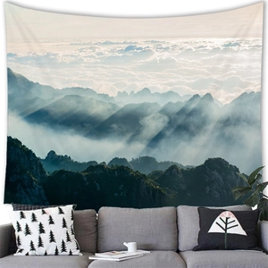 Detail showing the landscape wall tapestry fabric texture above a modern sofa