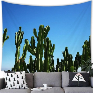 Detailed view of a desert cactus tapestry hung above a sofa in a modern living room decor