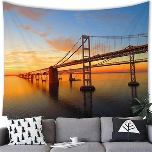 High-definition sunset beach tapestry hanging over a modern sofa in a cozy living room