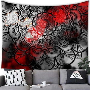 Detailed texture of red and black mandala tapestry hung over a sofa in a modern living room