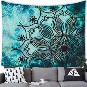 Detail of bohemian teal mandala tapestry on grey living room wall background