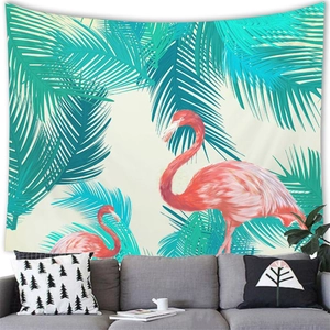 Tropical flamingo and palm leaf tapestry hanging over a sofa in a modern living room