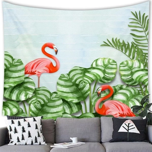 Tropical monstera leaf and flamingo tapestry hanging above a modern living room sofa